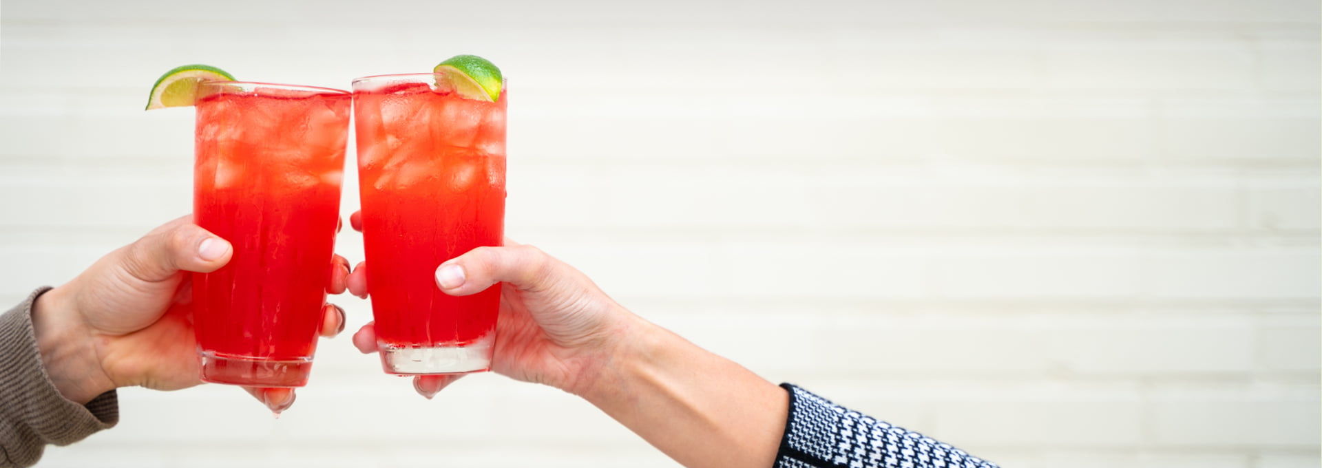 Cheers! Friends raise glasses of fresh Pomegranate Pear Punch