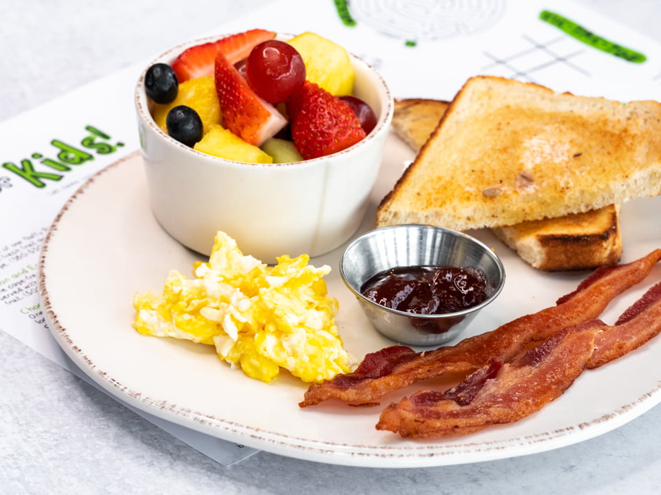 One egg cooked any way you like, bacon, sourdough toast and fresh fruit.