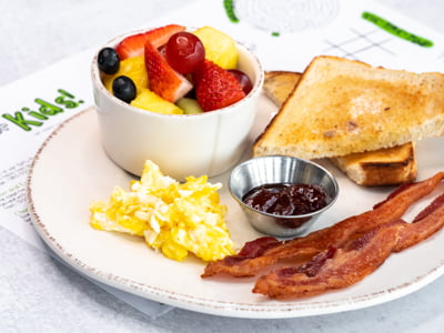One egg cooked any way you like, bacon, sourdough toast and fresh fruit.