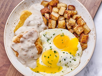 One large freshly baked buttermilk biscuit split in two with homestyle turkey sausage gravy, two cage-free eggs any style and a side of fresh, seasoned potatoes.