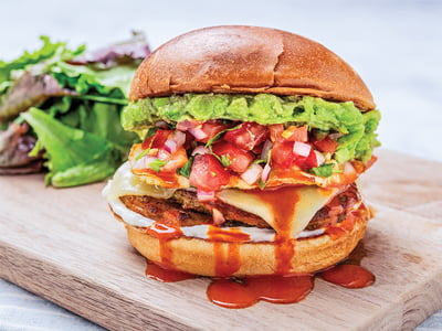 Two savory chorizo sausage patties, fresh smashed avocado, melted Monterey Jack cheese and an over-easy cage-free egg topped with Cholula, mayo and housemade pico de gallo on a grilled brioche bun. Served with lemon-dressed organic mixed greens.