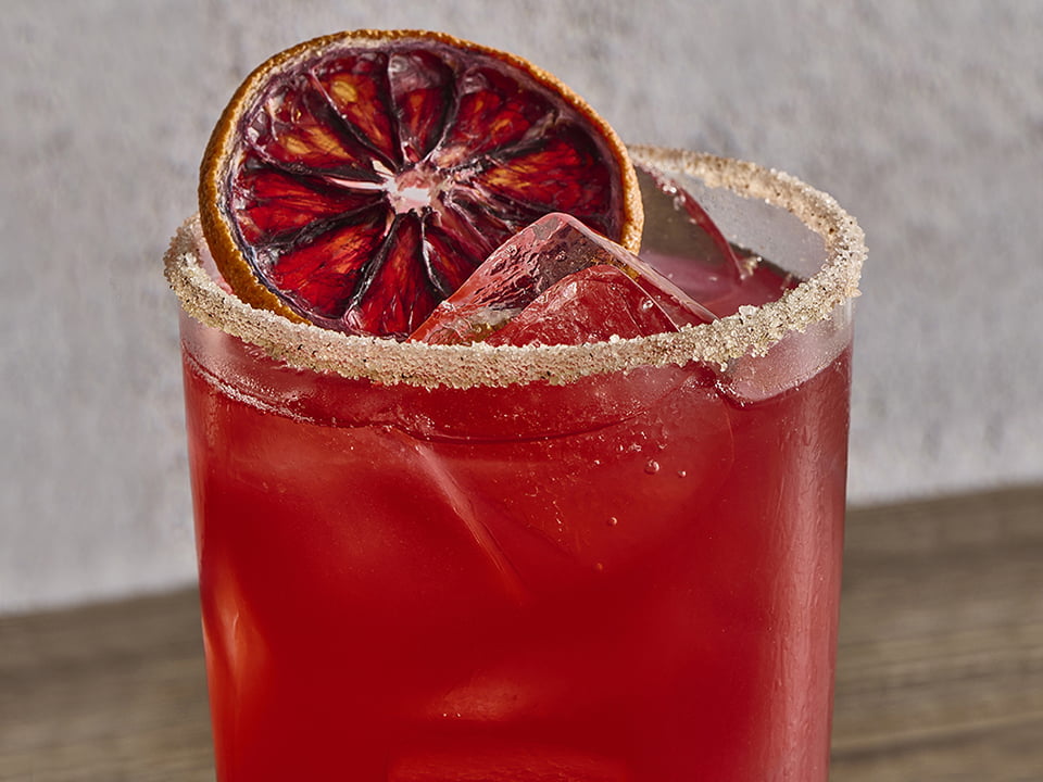 Hibiscus tea, cranberry, orange, pineapple, lemon and ginger with a cinnamon-spiced sugar rim.