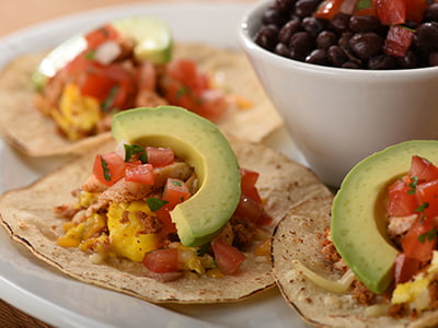 Three wheat-corn tortillas with scrambled cage-free eggs, Cajun chicken, chorizo, Cheddar and Monterey Jack. Topped with fresh avocado and housemade pico de gallo. Served with seasoned black beans.