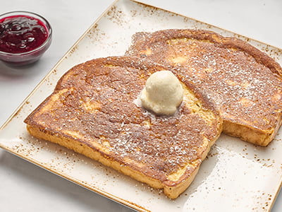 Custard-dipped, thick-cut brioche bread with whipped butter, powdered cinnamon sugar and warm mixed berry compote.