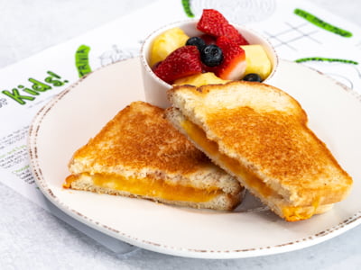 Ooey-gooey cheese melted between two pieces of grilled sourdough bread. Served with fresh fruit.