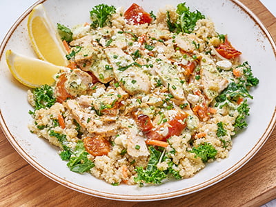Protein-packed quinoa, kale, shredded carrots and house-roasted tomatoes topped with all-natural chicken breast, basil pesto sauce, lemon white balsamic dressing, Feta cheese and fresh herbs.
