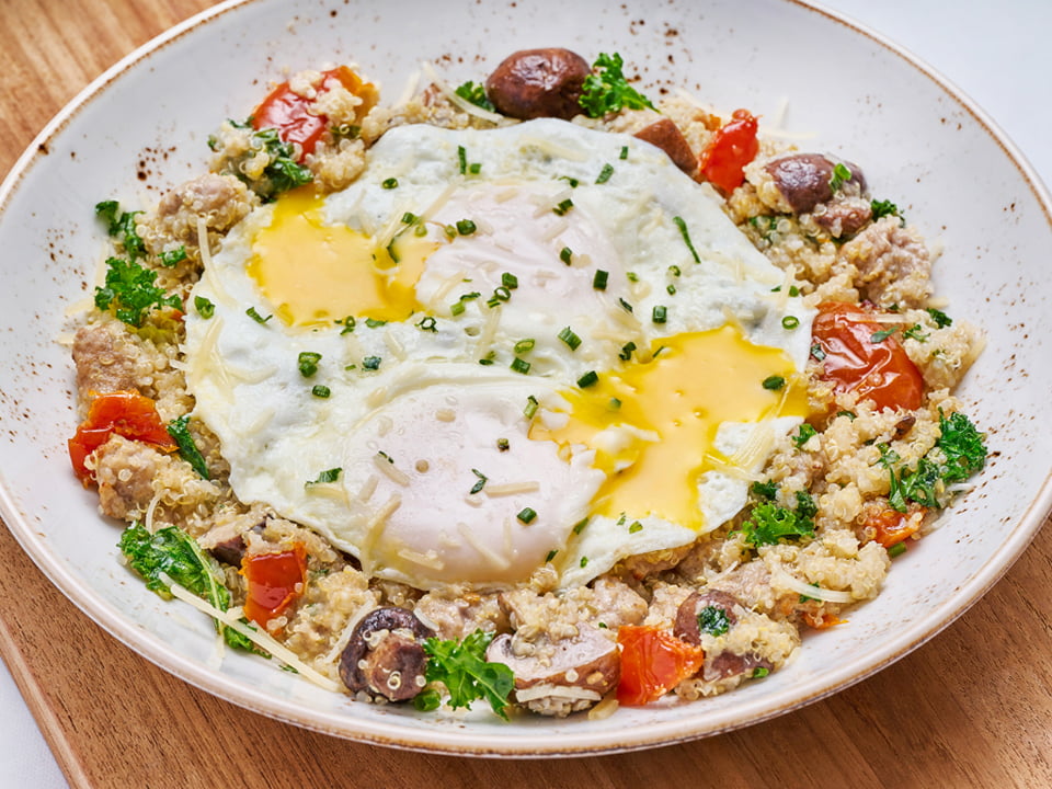 Protein-packed quinoa, Italian sausage, house-roasted Crimini mushrooms and tomatoes, kale, Parmesan, lemon white balsamic dressing and EVOO. Topped with two basted cage-free eggs.