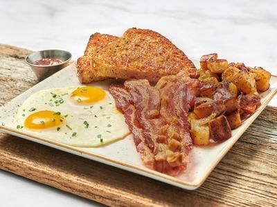 Two cage-free eggs any style with your choice of bacon, smoked ham, chicken sausage patties, turkey or pork sausage links. Served with whole grain artisan toast, all-natural house preserves and fresh, seasoned potatoes. Substitute Gluten Free toast at no additional charge.