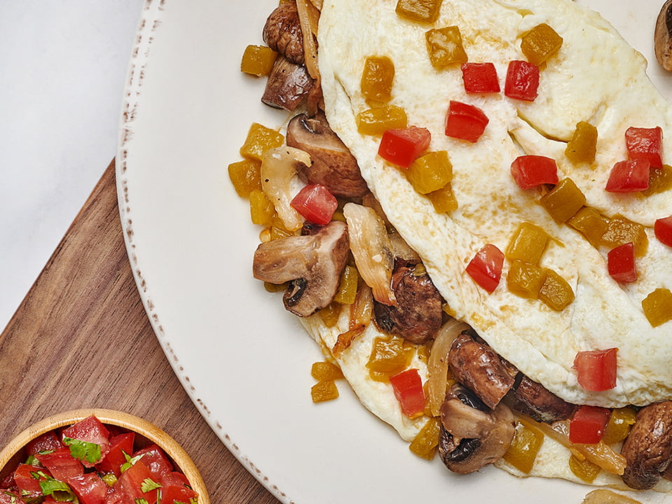 House-roasted Crimini mushrooms, onions, tomatoes and green chiles in a cage-free egg white omelet. Served with housemade pico de gallo, our whole grain artisan toast, all-natural house preserves and fresh fruit.