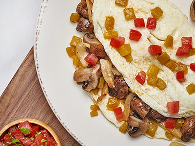Egg white omelet with house-roasted Crimini mushrooms, onions, tomatoes and green chilies. Served with housemade pico de gallo, our whole grain artisan toast, all-natural house preserves and fresh fruit.