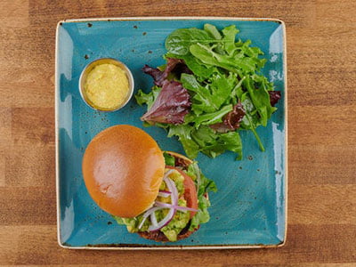 A seasoned all-natural patty of brown rice, Peppadew peppers, onions, carrots and mushrooms. Served on a brioche bun with fresh smashed avocado, organic mixed greens, tomato, red onion and a side of Dijonnaise.