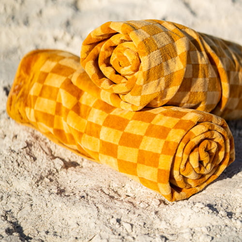 Two orange towels on the sand